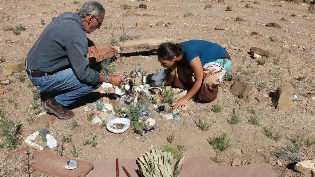 Jose and Anna begin a shamanic healing at a natural altar outside.